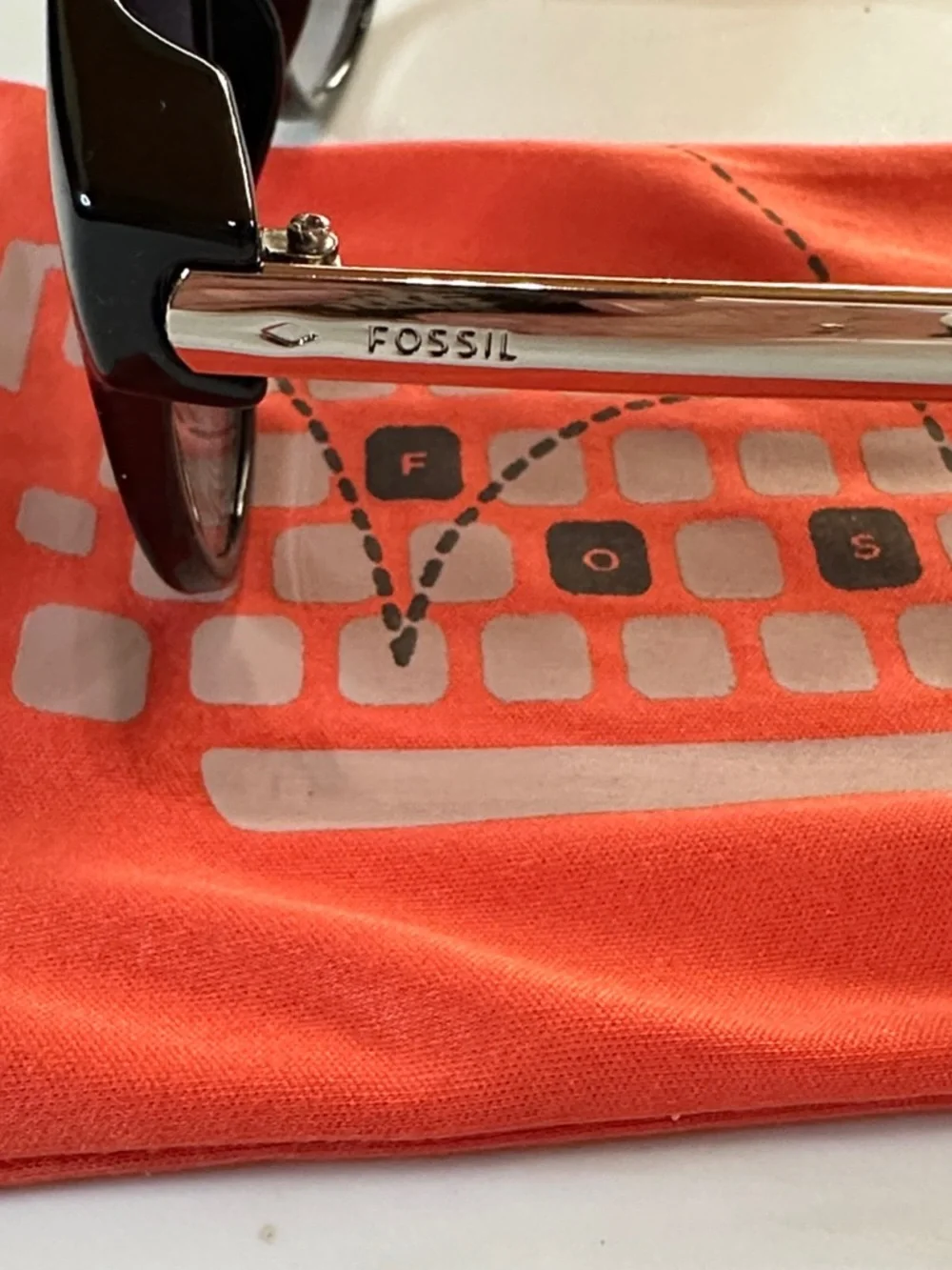 Fossil Semi Cat-Eye Sunglasses with Black & Silver Frame. 100% UV Protection
